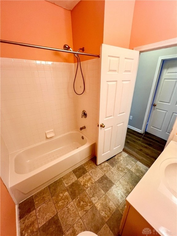 bathroom with vanity, hardwood / wood-style flooring, and shower / bath combination