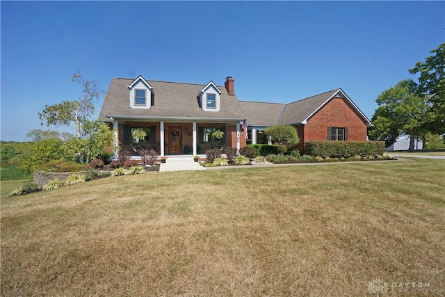 cape cod-style house featuring a front yard and a porch