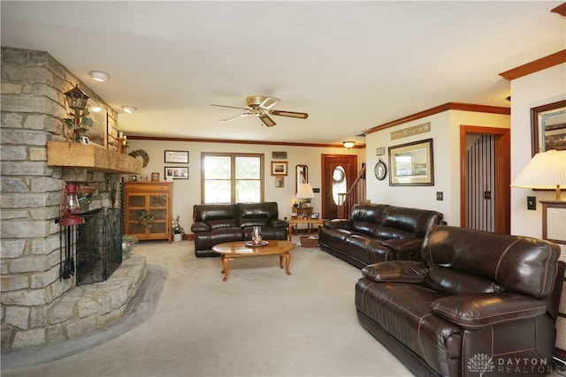 living room with a fireplace, light colored carpet, ornamental molding, and ceiling fan