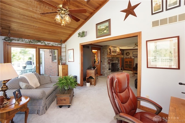 carpeted living room featuring wood ceiling, ceiling fan, a stone fireplace, and vaulted ceiling