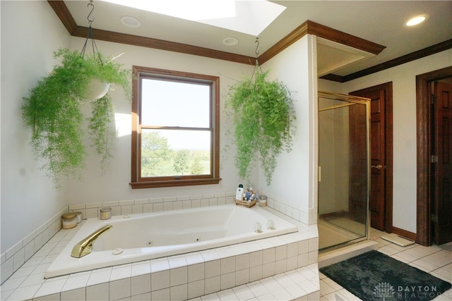 bathroom with a skylight, plenty of natural light, shower with separate bathtub, and tile patterned floors