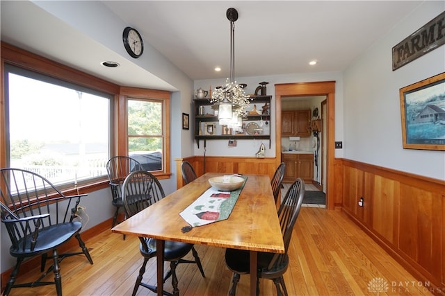 dining room featuring a chandelier and light hardwood / wood-style flooring