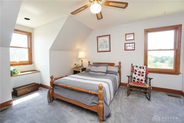 carpeted bedroom with ceiling fan and vaulted ceiling