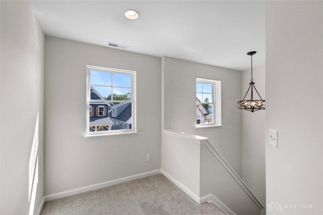 empty room featuring light colored carpet