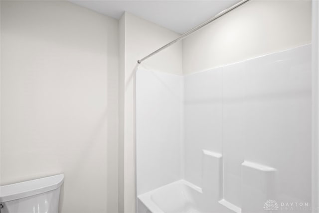 bathroom with toilet and shower / washtub combination