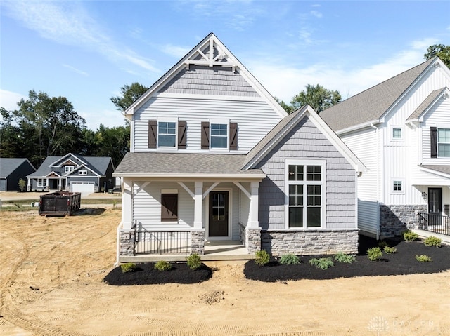 view of front of house featuring a garage and a porch