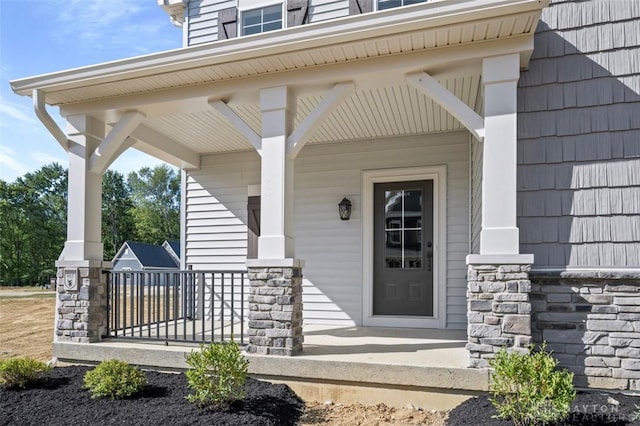 view of exterior entry with a porch