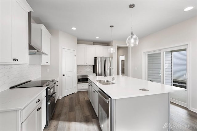 kitchen featuring stainless steel appliances, light countertops, a sink, and dark wood finished floors