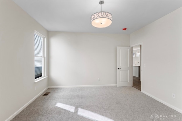 carpeted empty room featuring sink