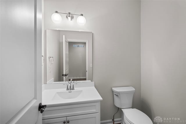 bathroom featuring toilet and vanity