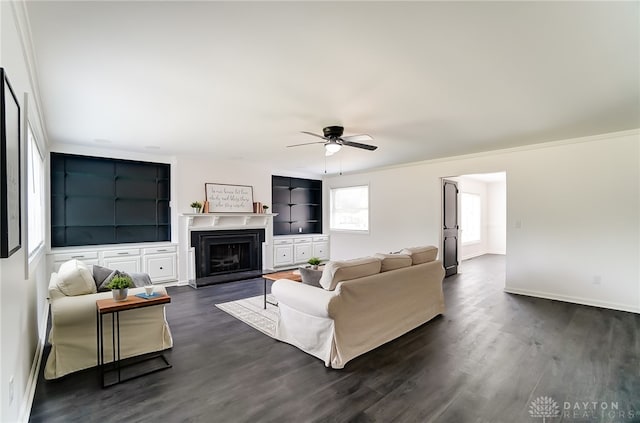 living room with ornamental molding, ceiling fan, and dark hardwood / wood-style floors