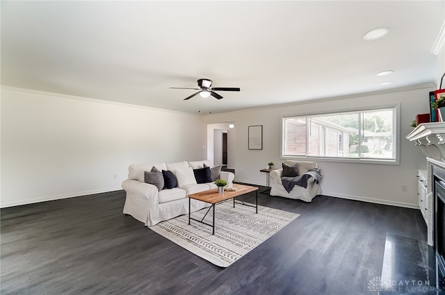 living room featuring crown molding, ceiling fan, and dark hardwood / wood-style floors