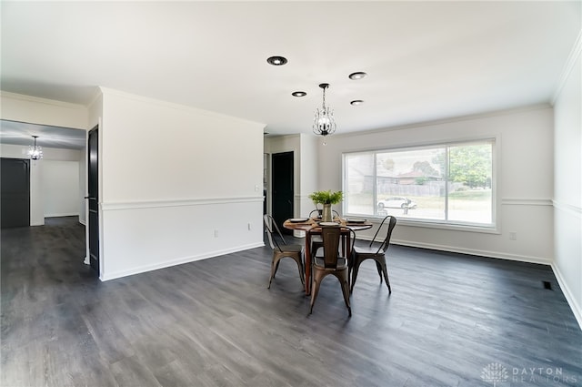 dining room featuring ornamental molding, a chandelier, and dark hardwood / wood-style floors