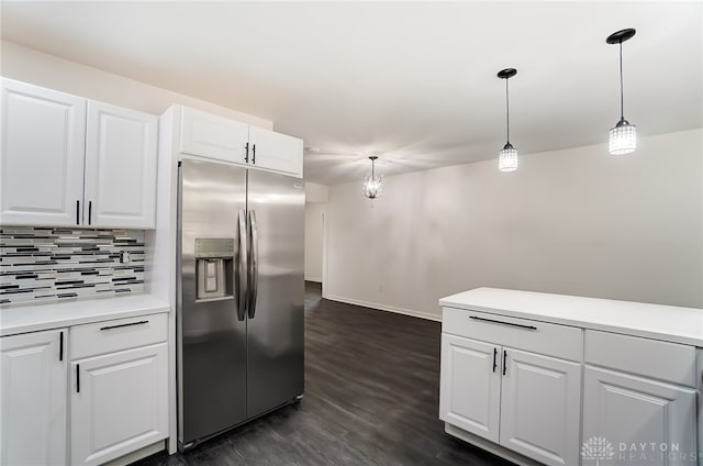 kitchen with decorative light fixtures, stainless steel refrigerator with ice dispenser, dark wood-type flooring, decorative backsplash, and white cabinets