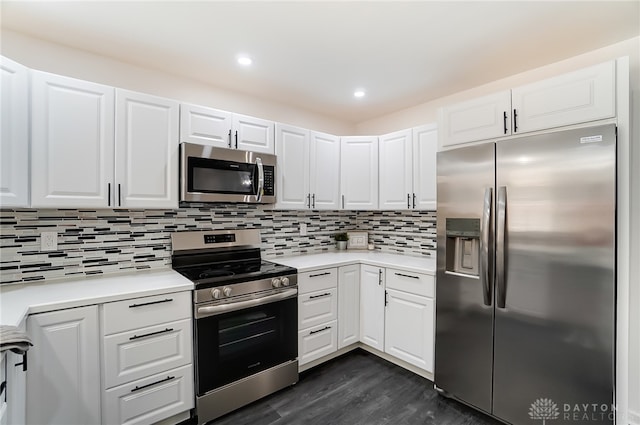 kitchen featuring appliances with stainless steel finishes, tasteful backsplash, white cabinets, and dark hardwood / wood-style floors