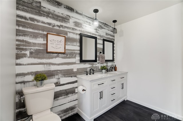 bathroom with vanity, toilet, and hardwood / wood-style flooring