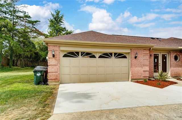 view of front of home with a garage and a front lawn