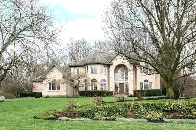 french country home featuring a front lawn