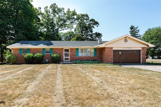 ranch-style home with a garage and a front yard