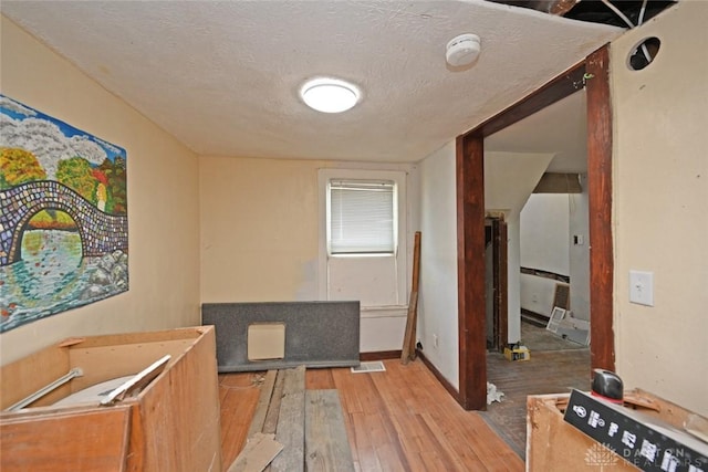 interior space featuring light hardwood / wood-style flooring and a textured ceiling