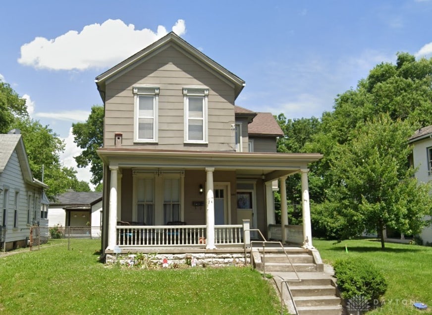 view of front of house featuring a front yard and a porch