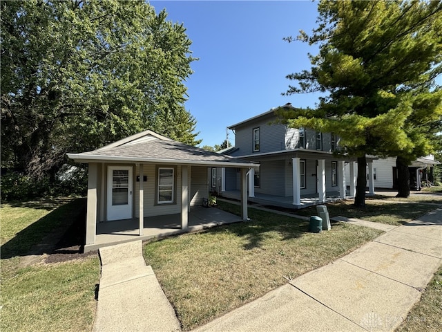 view of front facade with a front lawn and covered porch