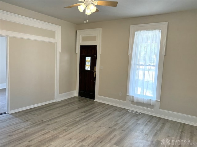 entrance foyer with ceiling fan and light hardwood / wood-style flooring