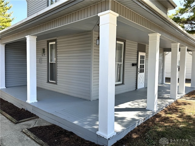 view of side of property with covered porch