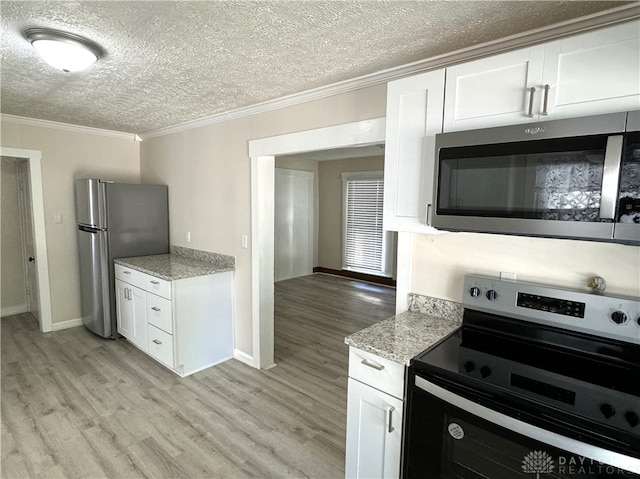 kitchen with light hardwood / wood-style flooring, stainless steel appliances, ornamental molding, and white cabinetry