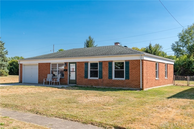 ranch-style home with a front yard and a garage