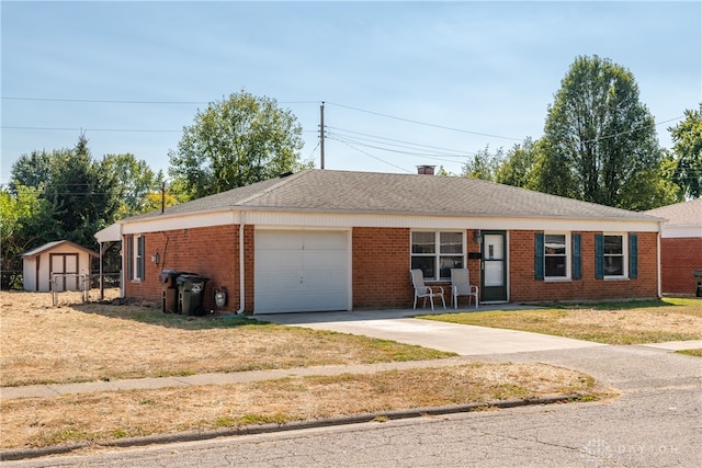 ranch-style house with a garage, a front lawn, and a storage shed