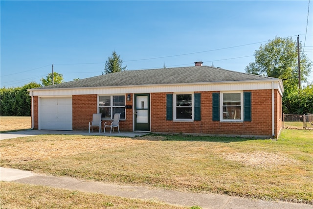 ranch-style home with a front yard and a garage