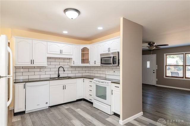 kitchen featuring white cabinets, white appliances, light hardwood / wood-style floors, and sink