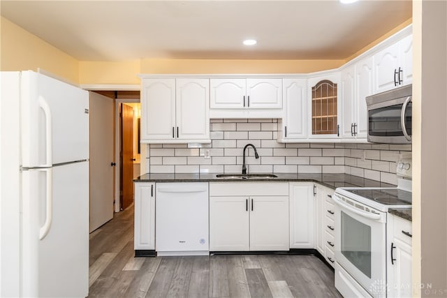 kitchen with light hardwood / wood-style floors, white appliances, sink, and white cabinetry