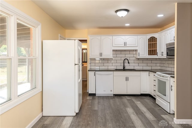 kitchen featuring dark hardwood / wood-style flooring, white cabinetry, sink, and white appliances