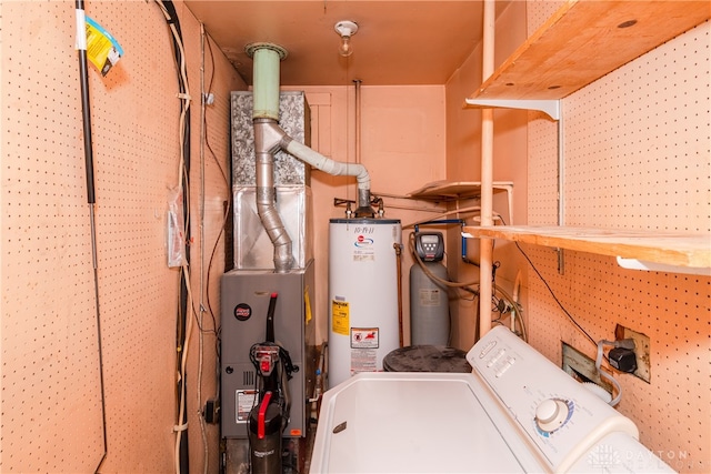 washroom featuring a workshop area, separate washer and dryer, and water heater