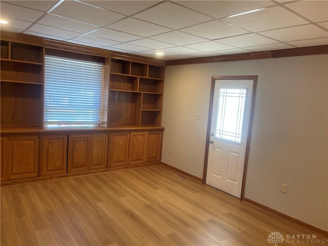 interior space with a paneled ceiling and light hardwood / wood-style floors