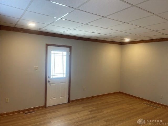 entrance foyer with a paneled ceiling and light hardwood / wood-style floors