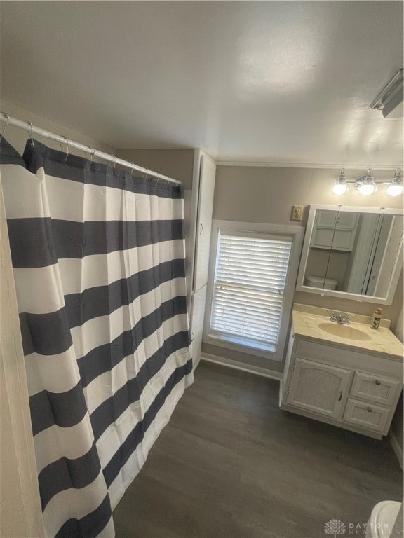 bathroom with vanity, hardwood / wood-style floors, and curtained shower