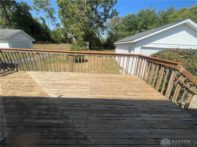 deck with a garage and an outbuilding