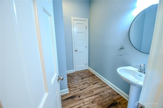 bathroom with hardwood / wood-style flooring