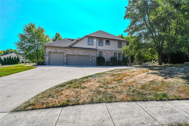 view of front of house with a front yard and a garage