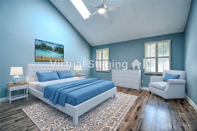 bedroom featuring ceiling fan, a skylight, hardwood / wood-style floors, and multiple windows