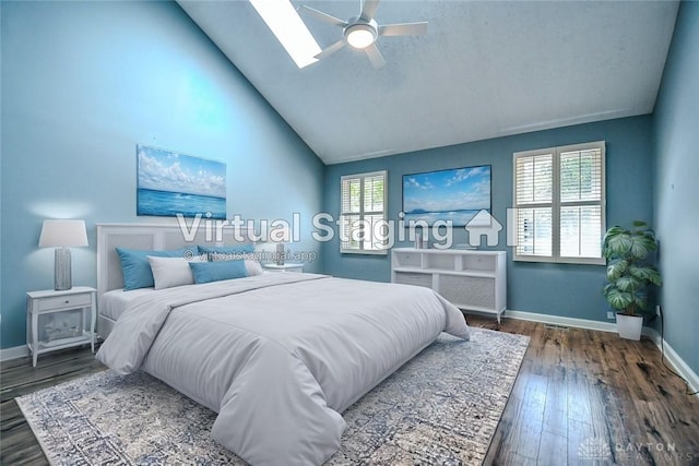 bedroom featuring ceiling fan, multiple windows, hardwood / wood-style flooring, and a skylight