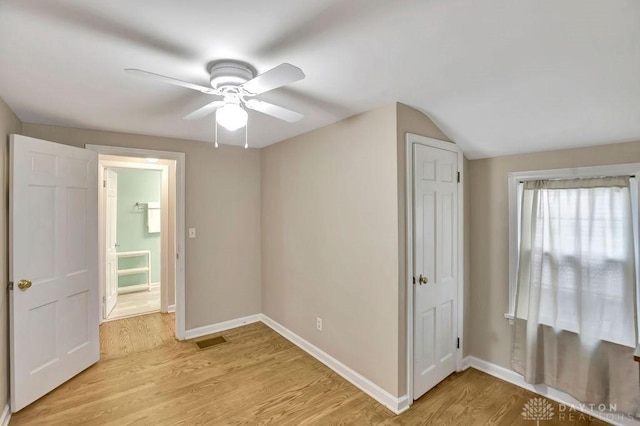 interior space featuring vaulted ceiling, light hardwood / wood-style floors, and ceiling fan