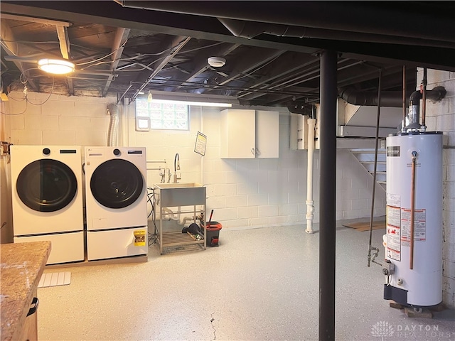 basement with separate washer and dryer, sink, and water heater