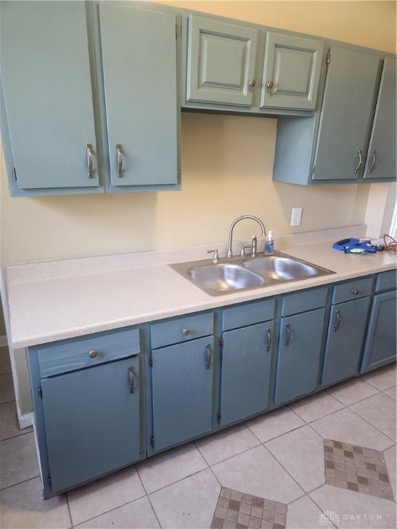 kitchen with sink and light tile patterned floors