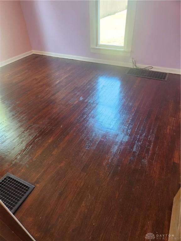 spare room with dark hardwood / wood-style floors