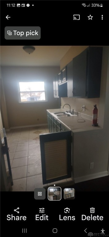 kitchen featuring sink and light tile patterned floors