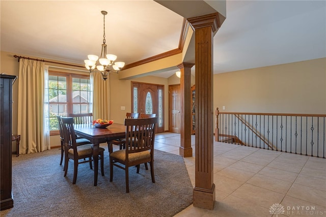 tiled dining area with ornamental molding, decorative columns, and a chandelier